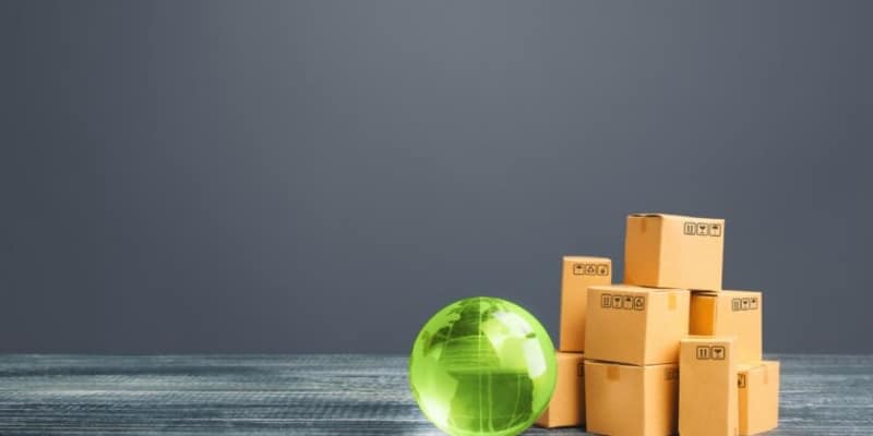 stack of boxes with clear green globe next to them